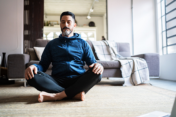 Man meditating at home