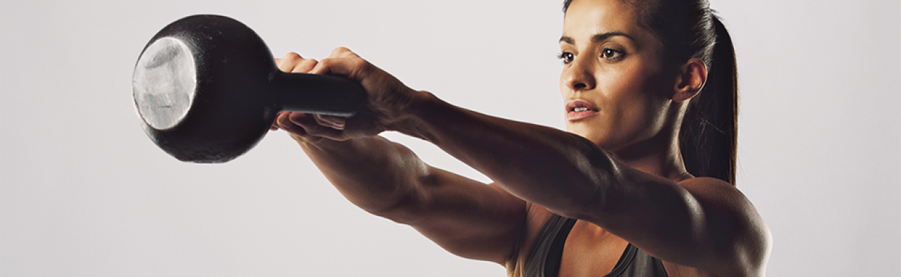 woman doing kettlebell swing | Adjustable Kettlebells