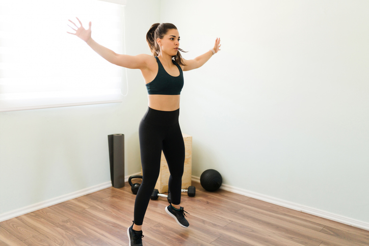 woman doing jumping jacks at home | Jumping Jacks Benefits