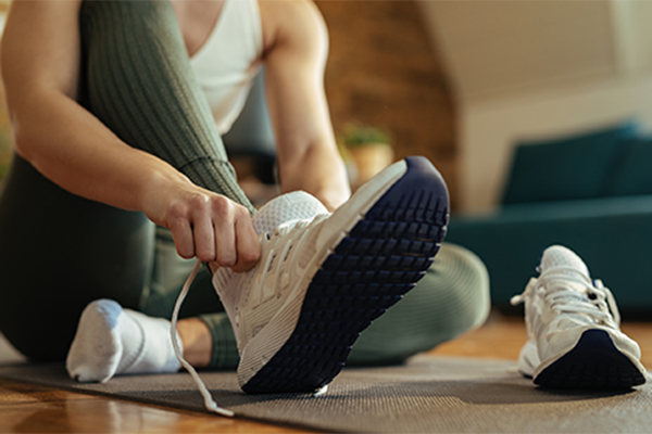 Woman putting running shoes on