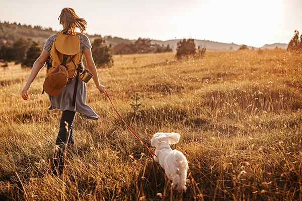 Woman hiking outdoors with dog