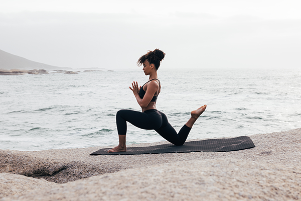 woman doing yoga on beach | How to Build Self-Esteem