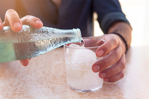 man pouring glass of water | Hydrogen Water