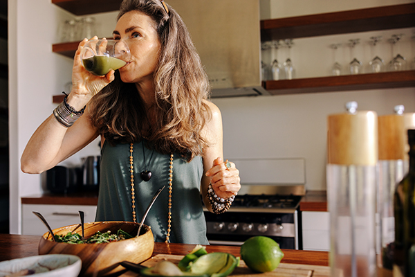 Woman drinking green juice