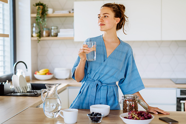 Woman holding glass of water