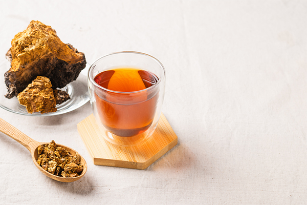 plate and spoon of mushrooms next to cup of mushroom tea | Mushroom Tea