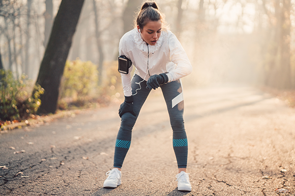 woman checking wrist watch on run | max heart rate