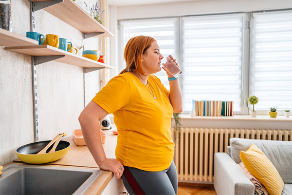 woman enjoying glass of water | How to Get Energy