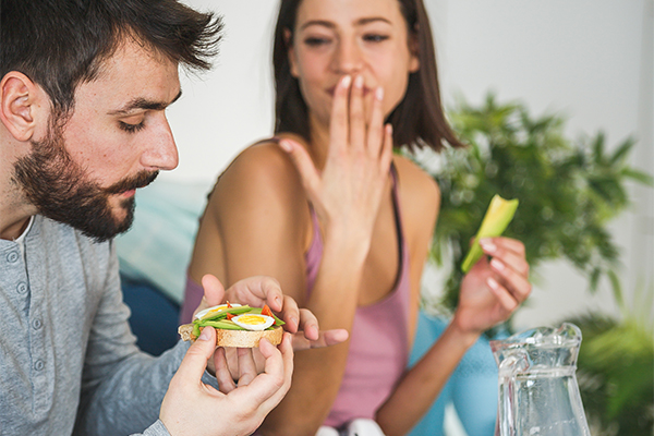man woman avocado toast giggle breakfast | healthy fats