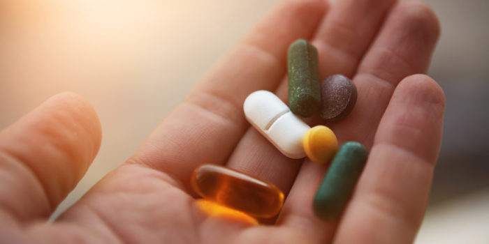 supplement pills in hand | antioxidants