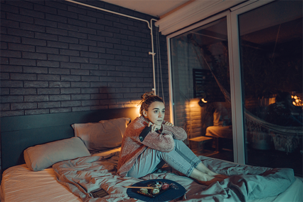 woman watching tv in bed
