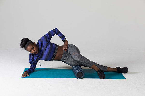 Woman Stretches with Foam Roller | What does a pulled muscle feel like