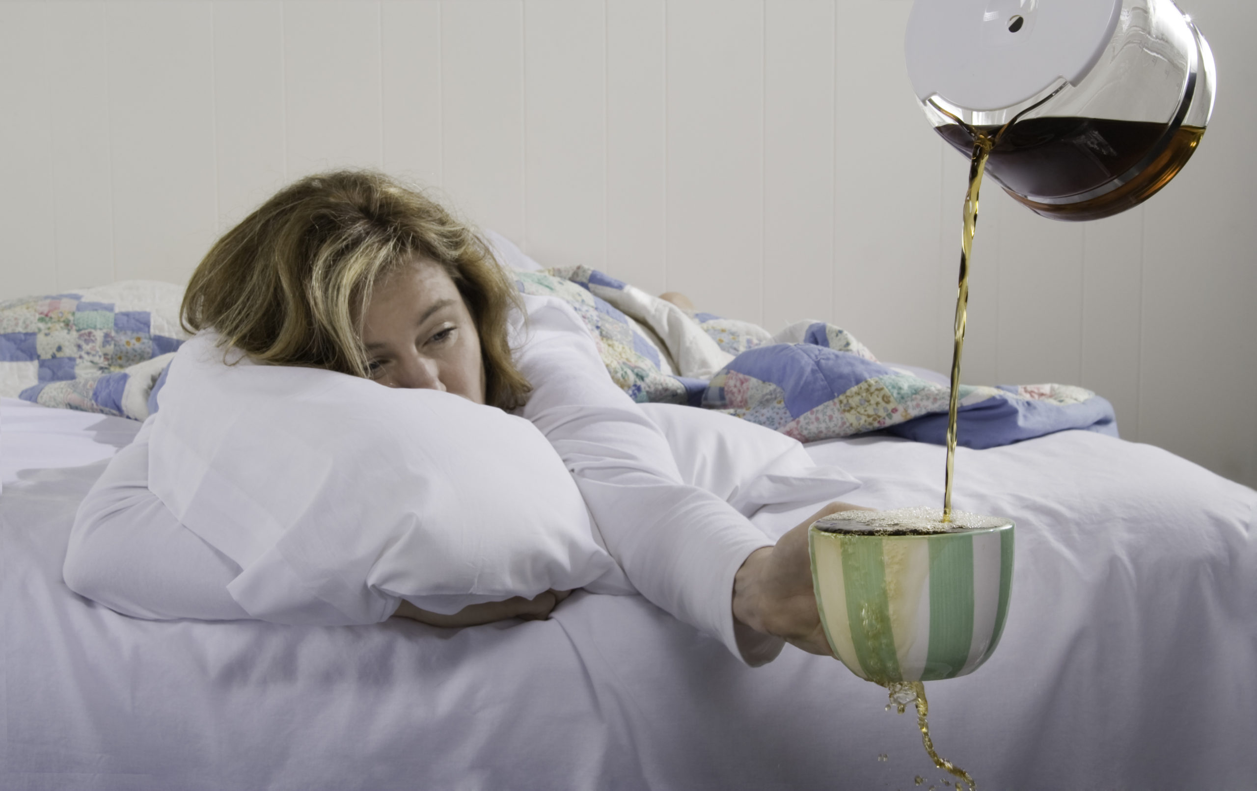 Woman in Bed | how much caffeine should you have a day
