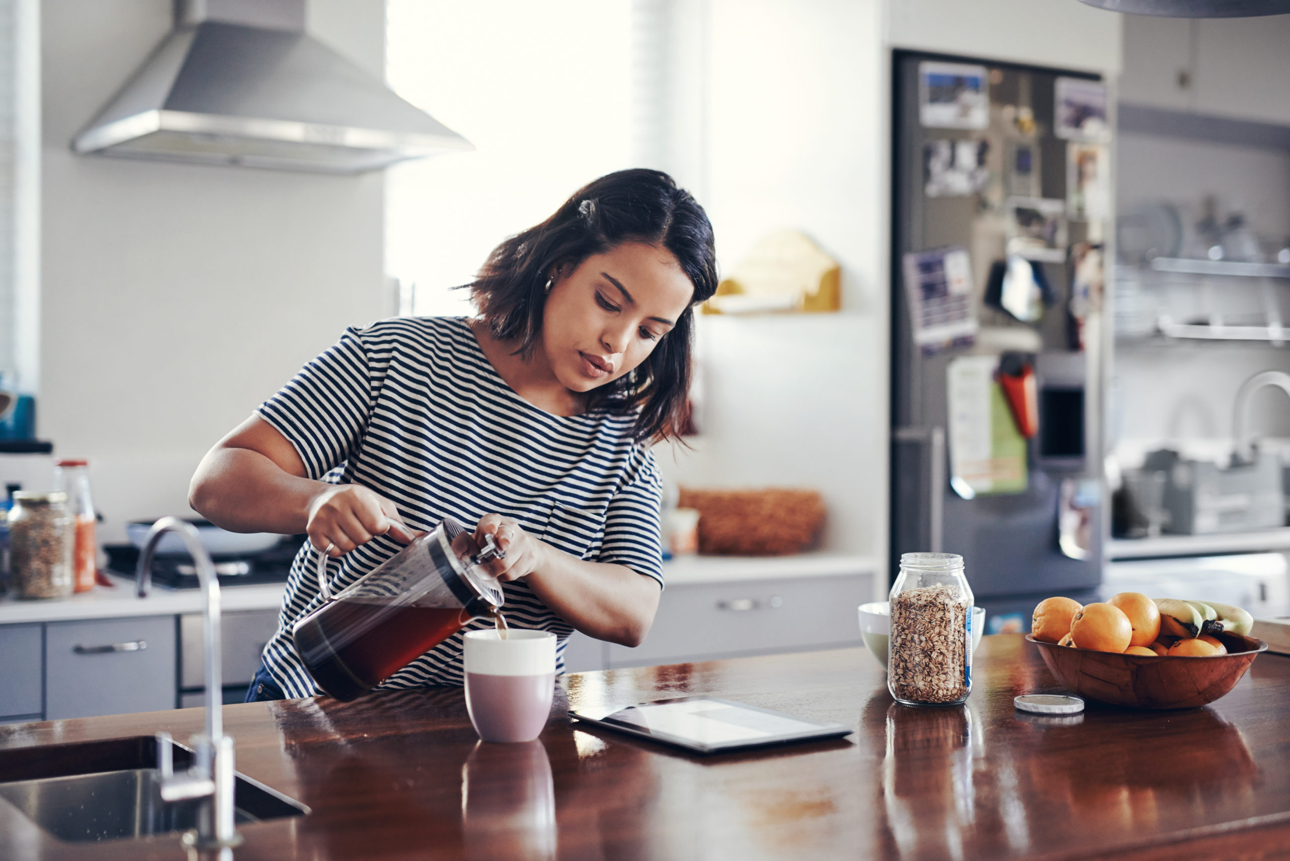 Woman in Kitchen | how much caffeine should you have a day