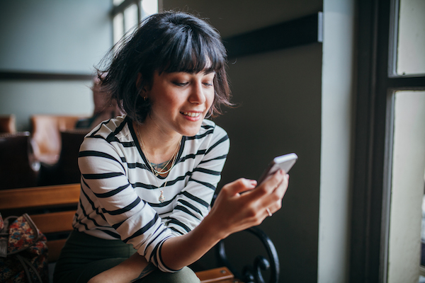 Woman Happy on Her Phone | Inexpensive Self Care