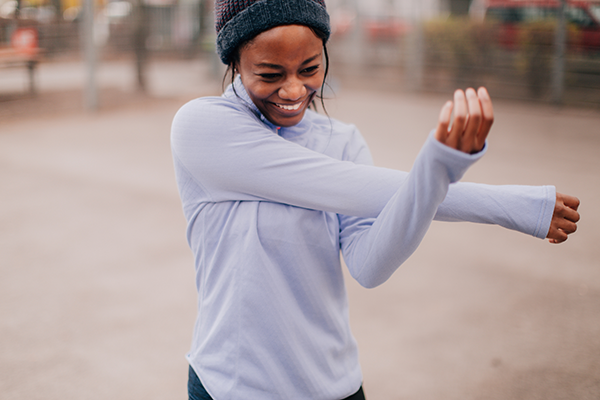 Woman Stretches During a Run | Intrinsic Motivation