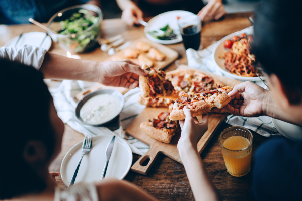 A group of people eat pizza Cyclia riding errors in closed places