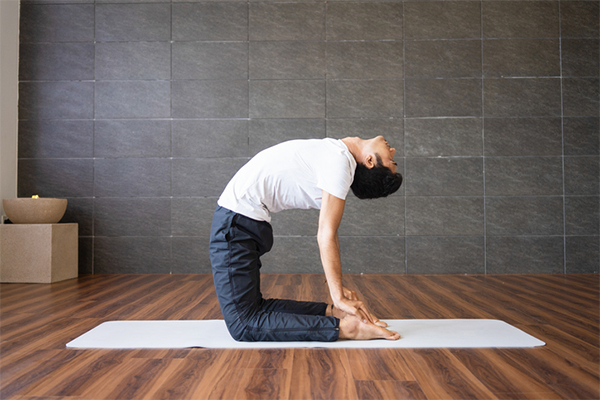 man doing camel pose | Camel Pose