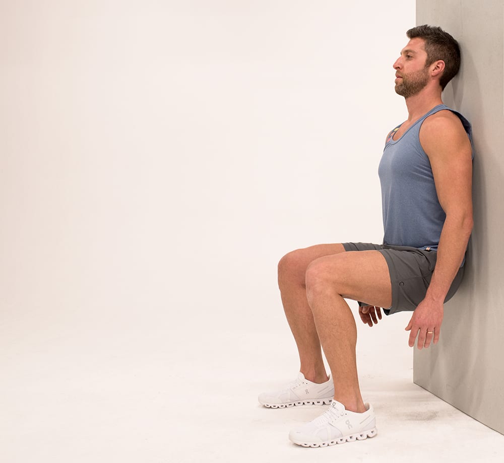 Man Holds a Wall Sit | Isometric Exercise