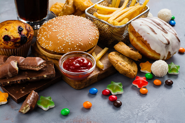 Variety of Fast Food on Gray Table | Ultra Processed Food