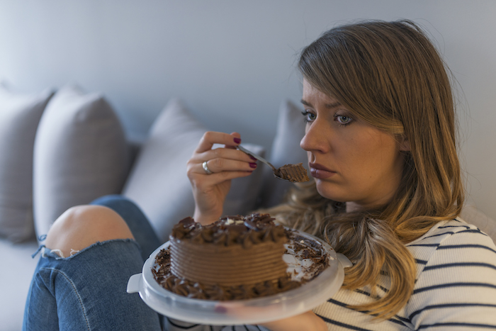 Woman Eats Cake on Couch | How To Stop Eating Sugar
