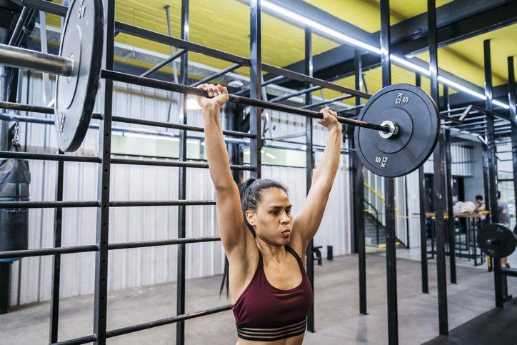 woman doing barbell shoulder press | dumbbell thruster