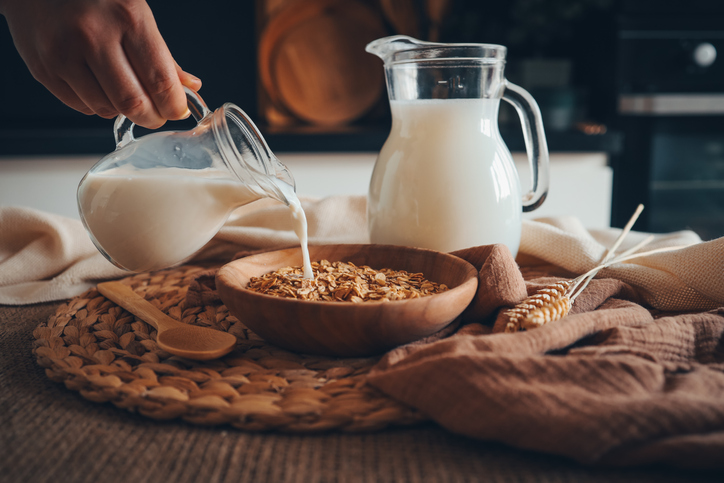 pouring milk into grains | Healthiest Milks