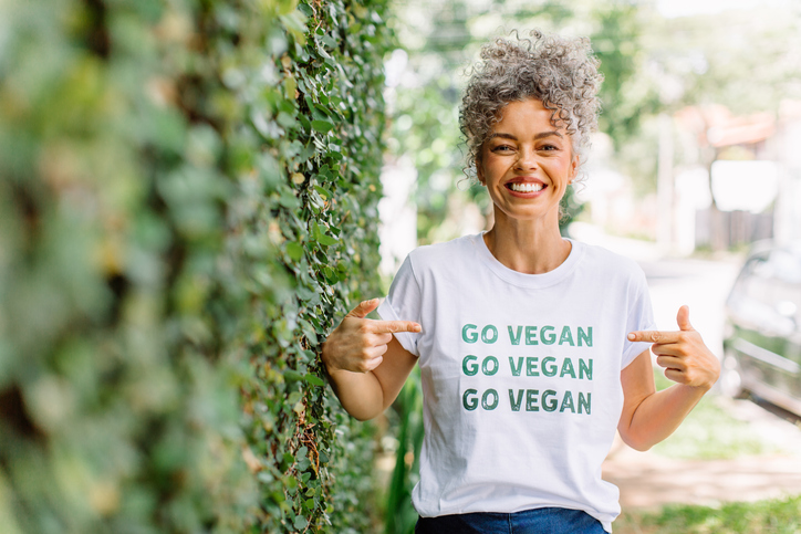 Happy Woman Points at Her "Go Vegan" Shirt | Vegan Facts