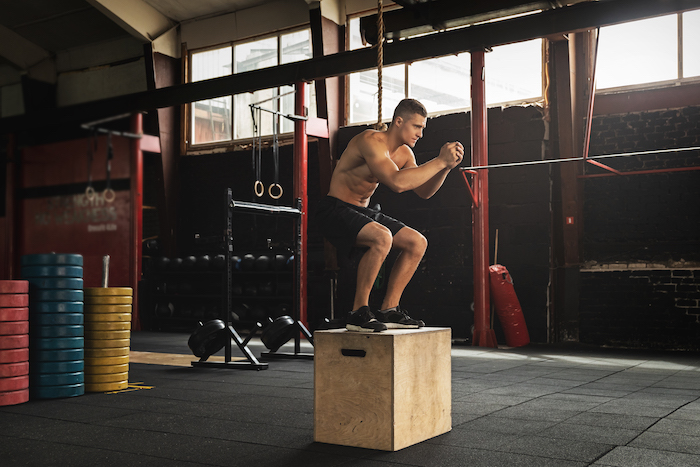 Image of Athlete Doing Box Jumps | EMOM Workouts