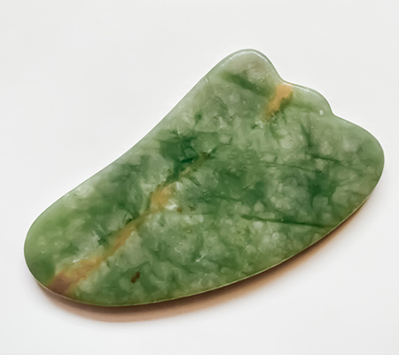 Isolated Image of Wing Gua Sha Tool | Gua Sha