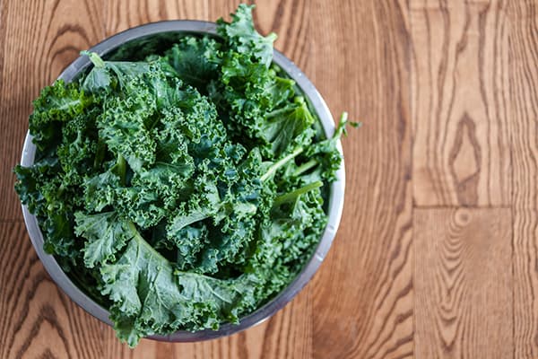 Overhead view of a bowl of kale | antioxidant foods