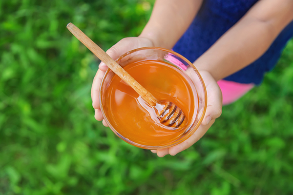 Bowl of Honey Held by Woman | Benefits of Honey