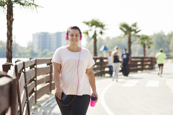 Woman Walks Along Beach | Is Walking Good Exercise