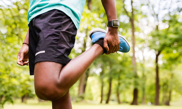 Man Stretches Quad in Woods | Cool Down Exercise