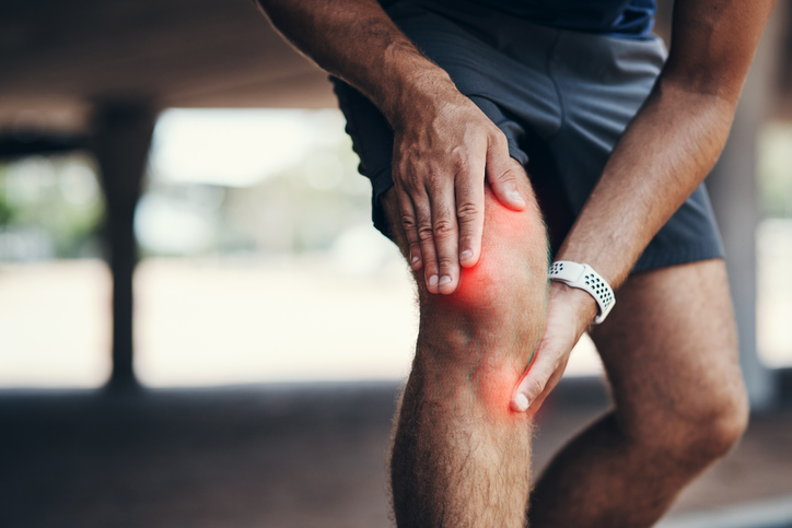 man holding onto knee | Benefits of Walking Backwards