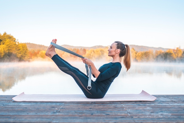 Woman Does Example of Boat Pose with Exercise Band | Boat Pose