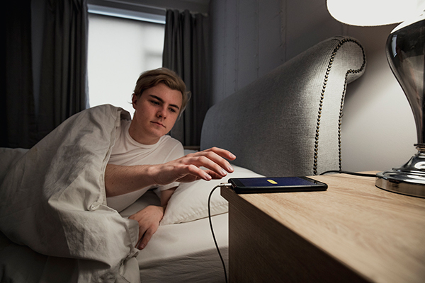 A man arrives to the phone to stop the alarm Morning meditation