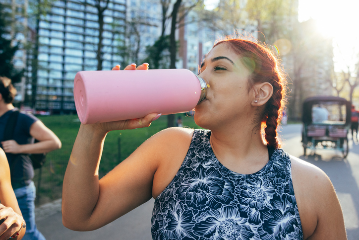 Woman Hydrates on Run | how to keep morning workouts from wearing you out