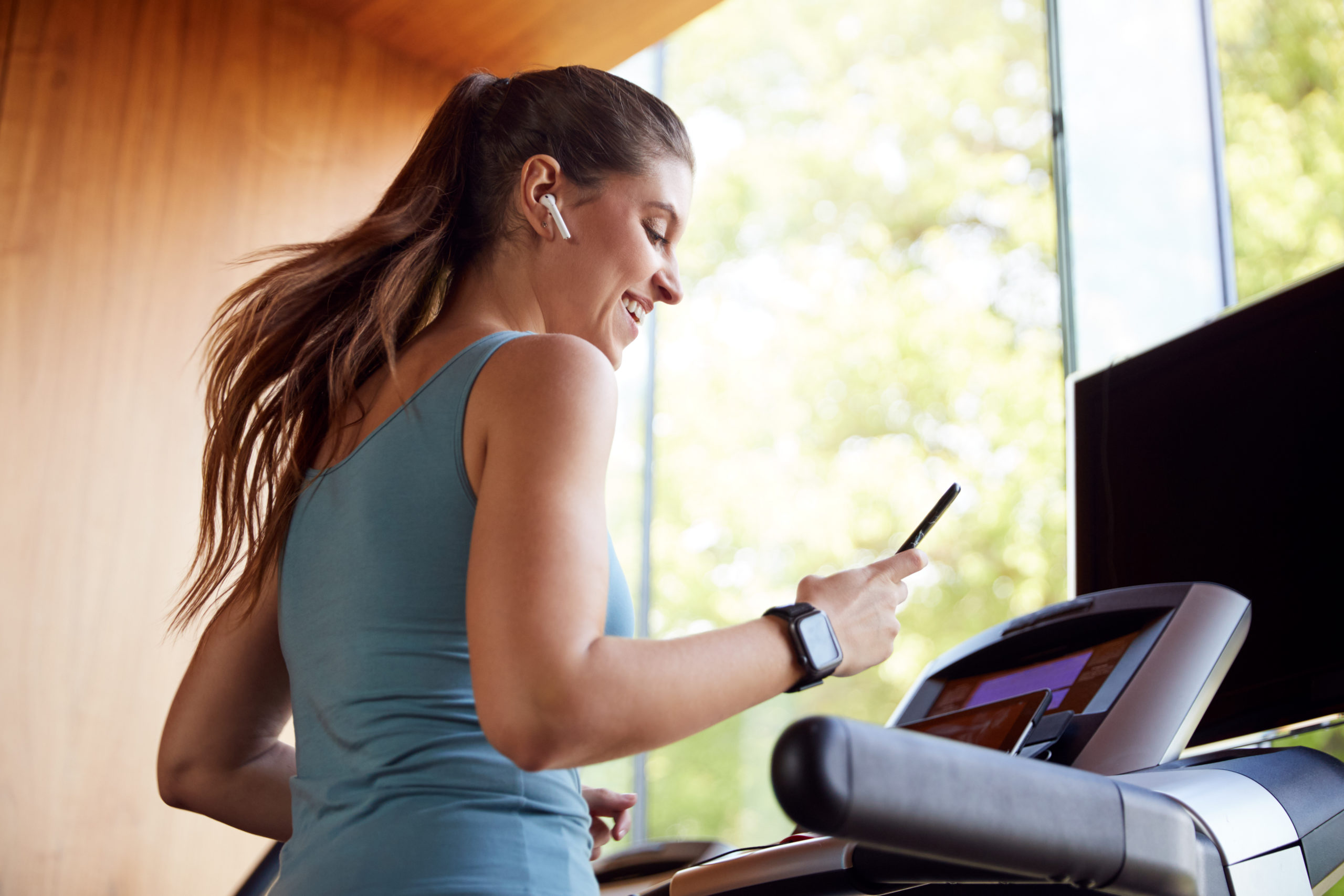 Woman Watches Show While on Treadmill | how to make running less boring