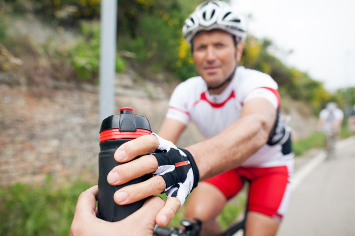 Cyclists receive drinks during event | During event