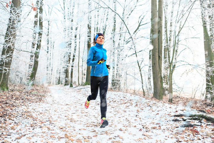 woman running in snow | Exercising in Cold Weather