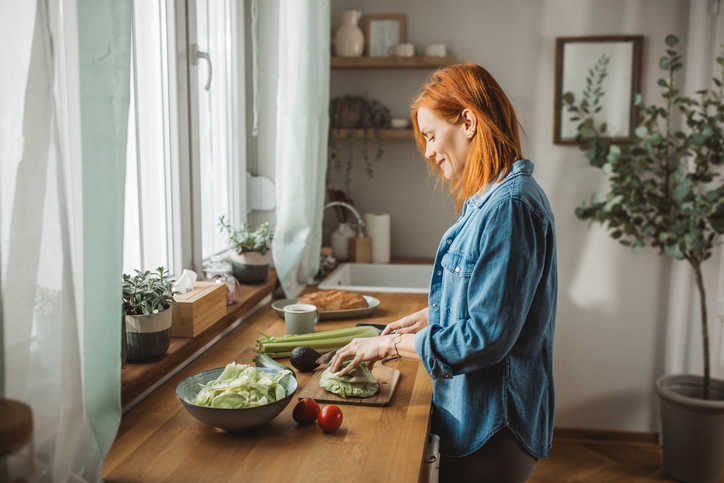 woman cooking | How to Lower Cortisol Naturally