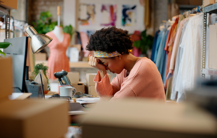 woman stressed at desk | How to Lower Cortisol Naturally