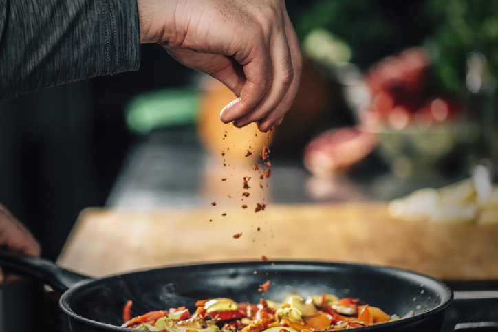 adding chili powder to dish | Ozempic Foods to Avoid