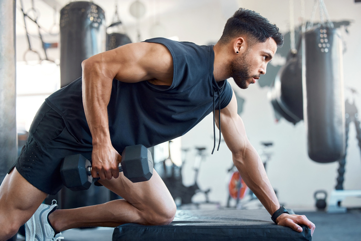 man doing an arm row | Body Types