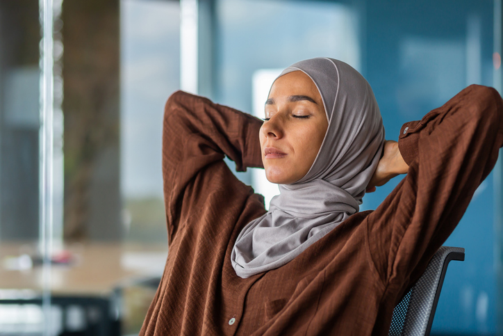 woman leaning on chair relaxing | Irregular Periods