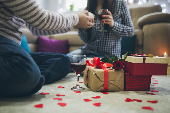 couple drinking wine exchanging gifts | Happy Valentine's Day