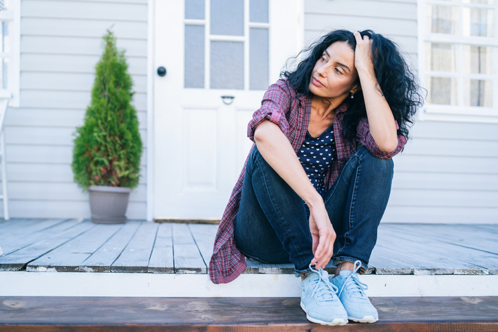 Woman meditating on balcony | Mood swings