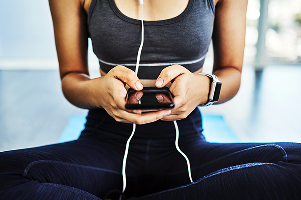 Woman working out, looking at social media on phone